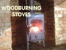 Woodburning stoves: a lit stove set in a brick fireplace