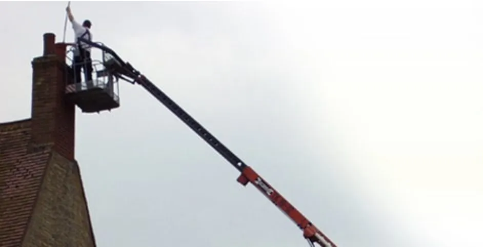 One of our team working on a chimney from a cherry picker