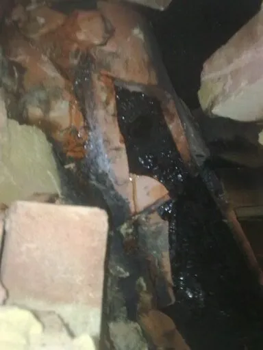 Close-up of a tar-blocked flue exposed inside a chimney breast